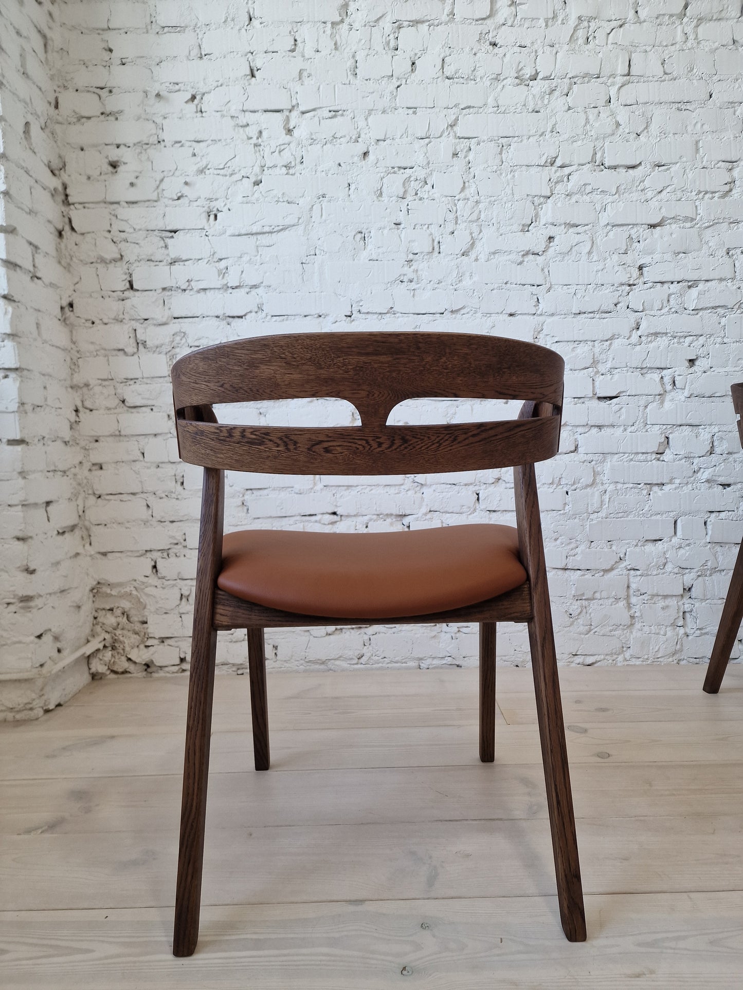 Solid walnut and natural leather curved dining chairs - style and high quality.