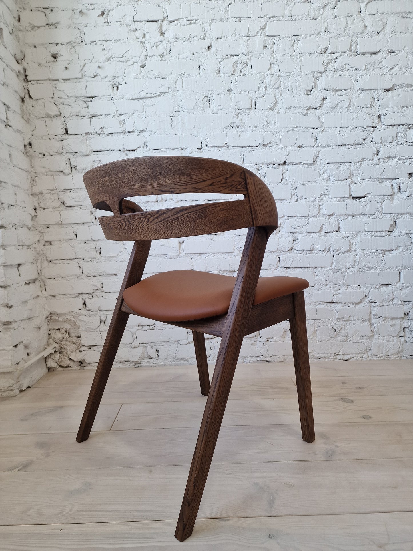 Solid walnut and natural leather curved dining chairs - style and high quality.