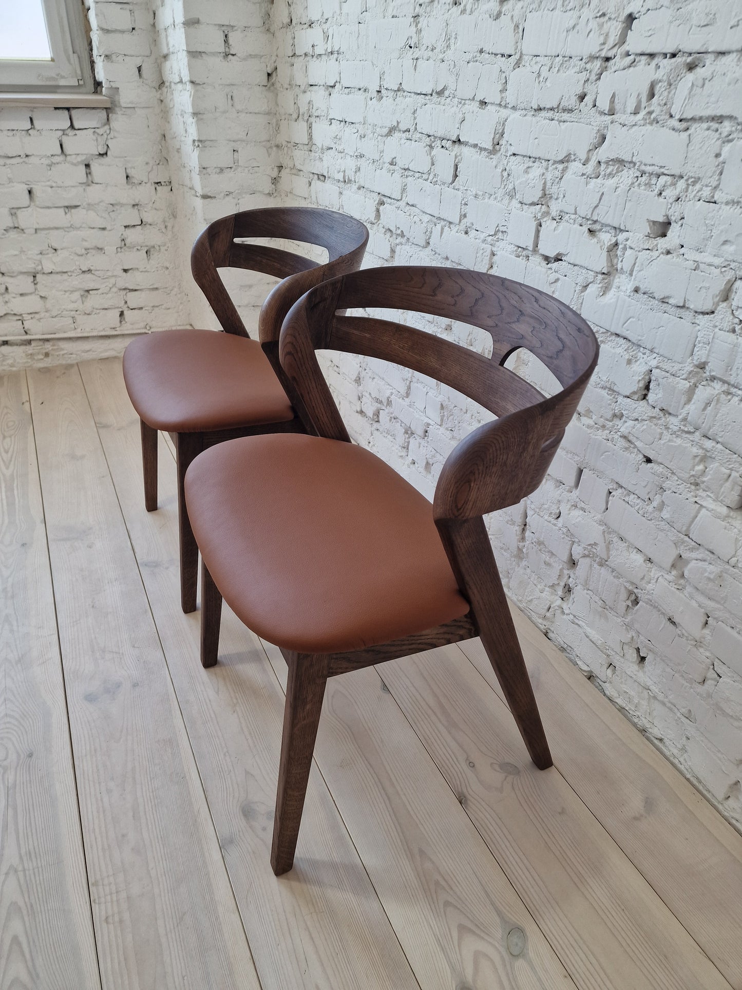 Solid walnut and natural leather curved dining chairs - style and high quality.
