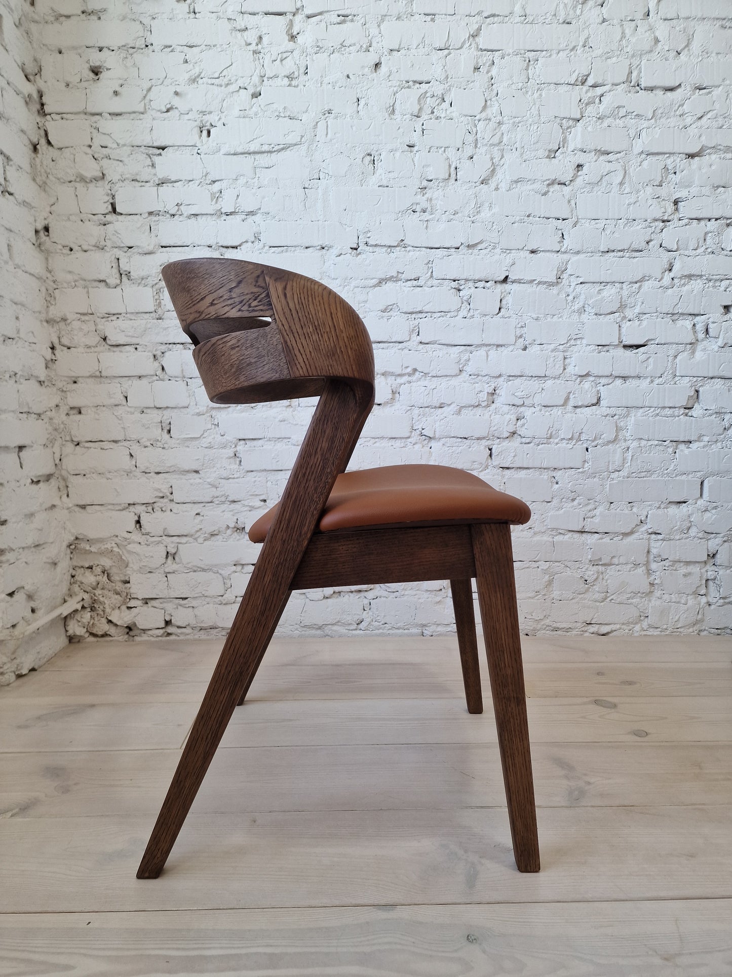 Solid walnut and natural leather curved dining chairs - style and high quality.