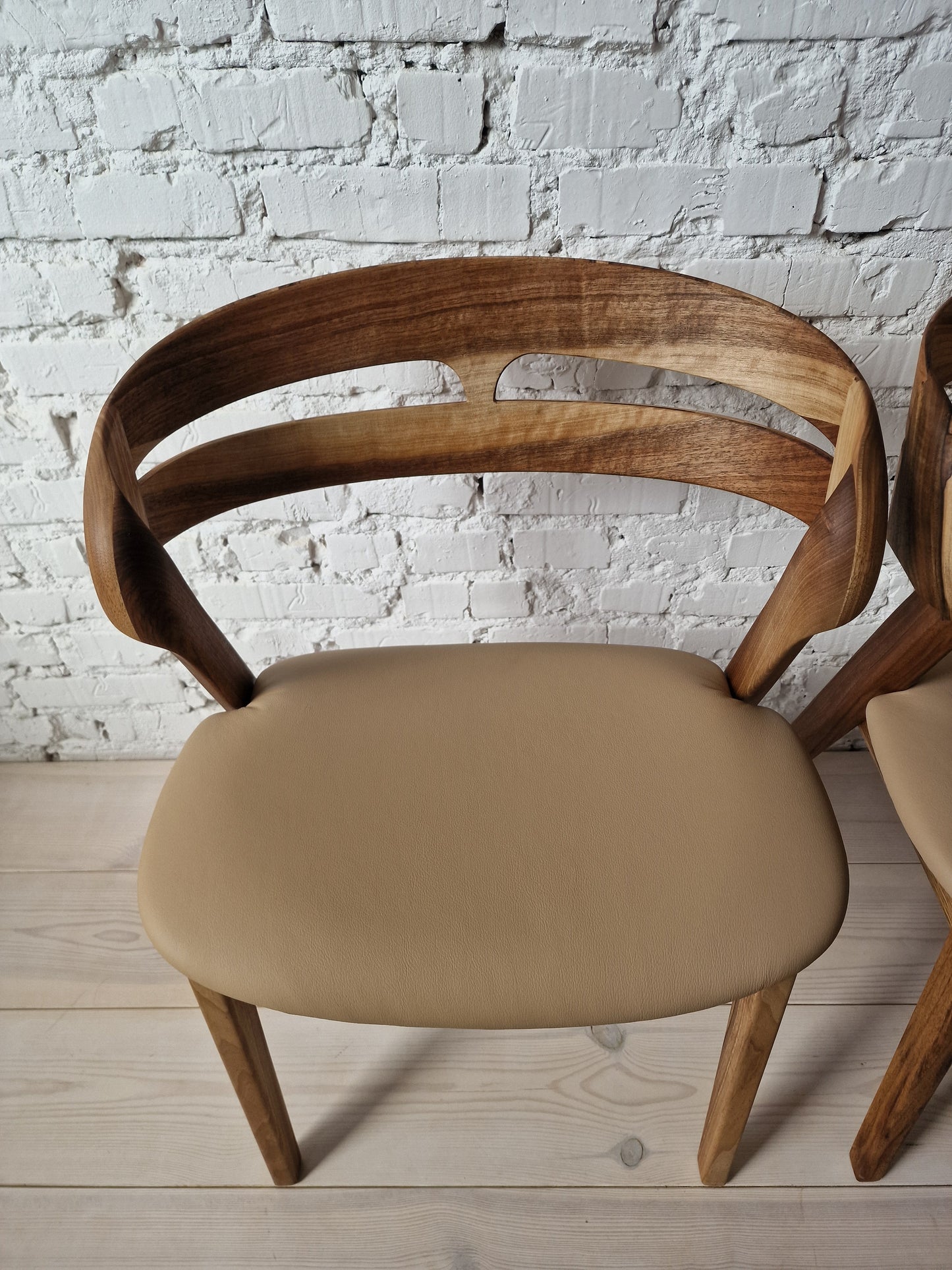 Solid walnut and natural leather curved dining chairs - style and high quality.