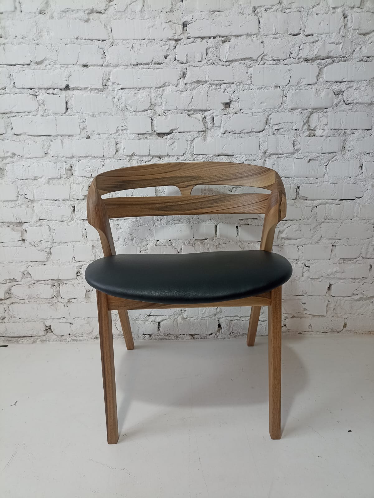 Solid walnut and natural leather curved dining chairs - style and high quality.