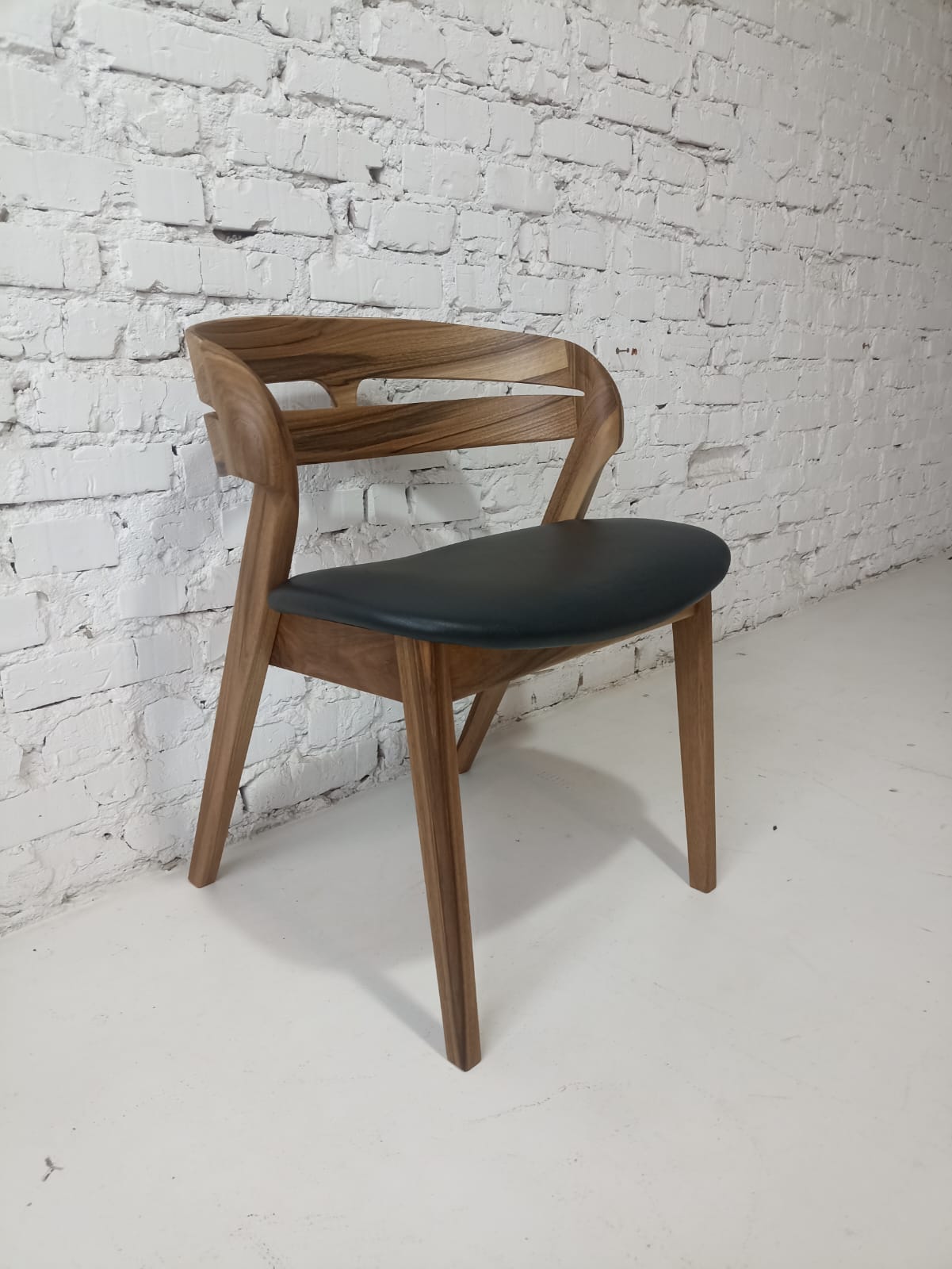 Solid walnut and natural leather curved dining chairs - style and high quality.