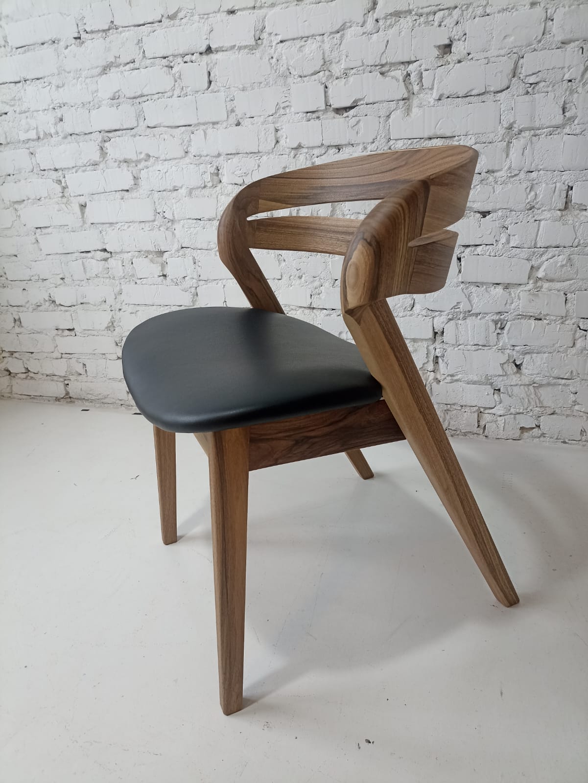 Solid walnut and natural leather curved dining chairs - style and high quality.