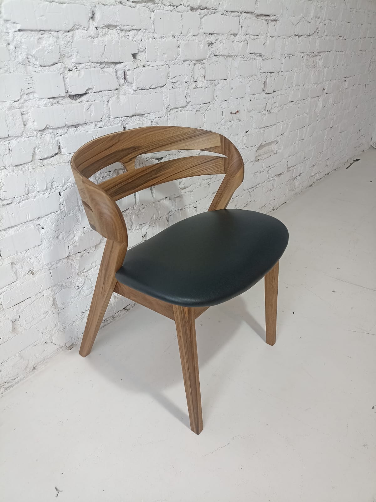 Solid walnut and natural leather curved dining chairs - style and high quality.