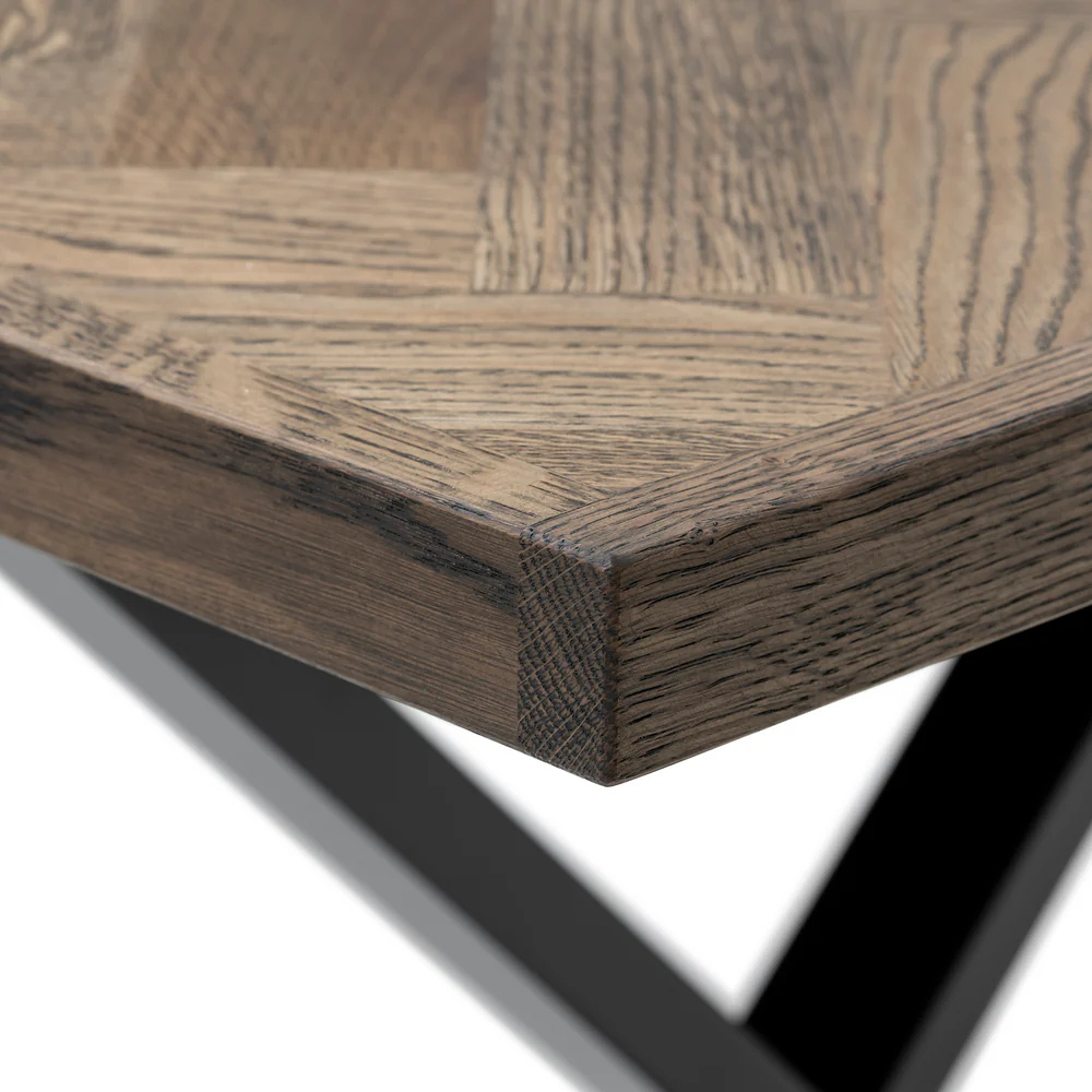 Gaia herringbone solid wood extendable dining table in charcoal oak with cross metal legs – luxury solid wood furniture piece.
