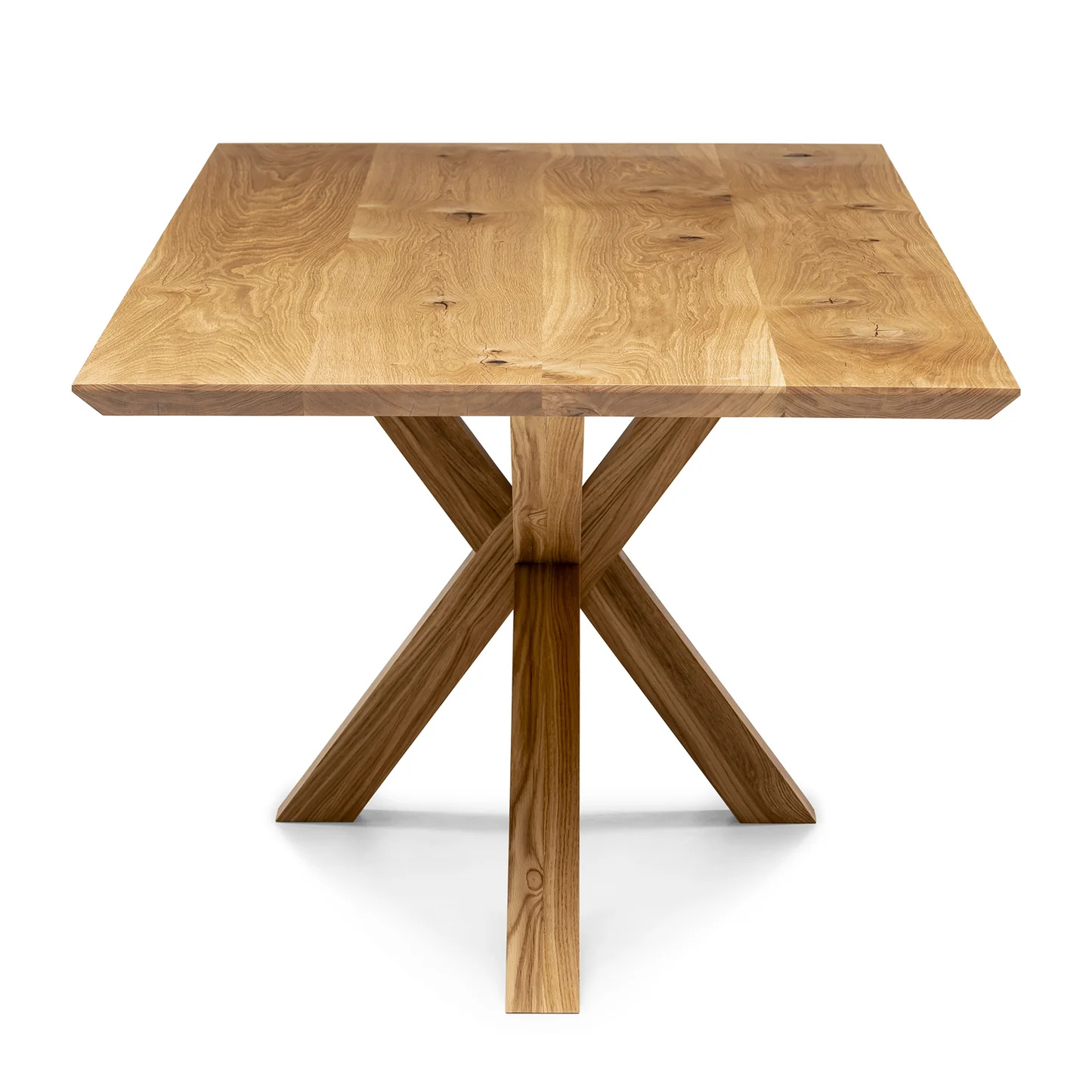 Minimalist solid oak dining table with sleek black wood spider legs.
