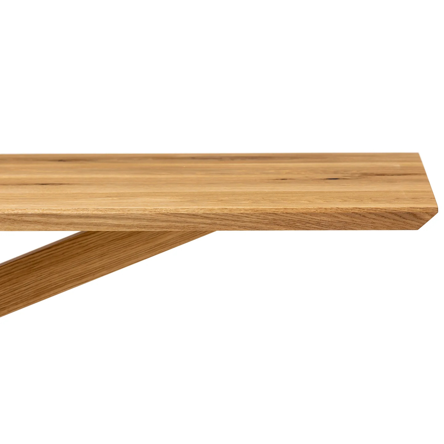 Elegant wooden dining table in natural oak with a bold spider leg frame.