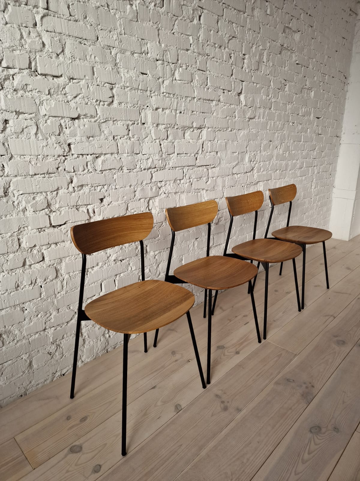 Solid wood dining chair with metal legs and a comfortable seat.