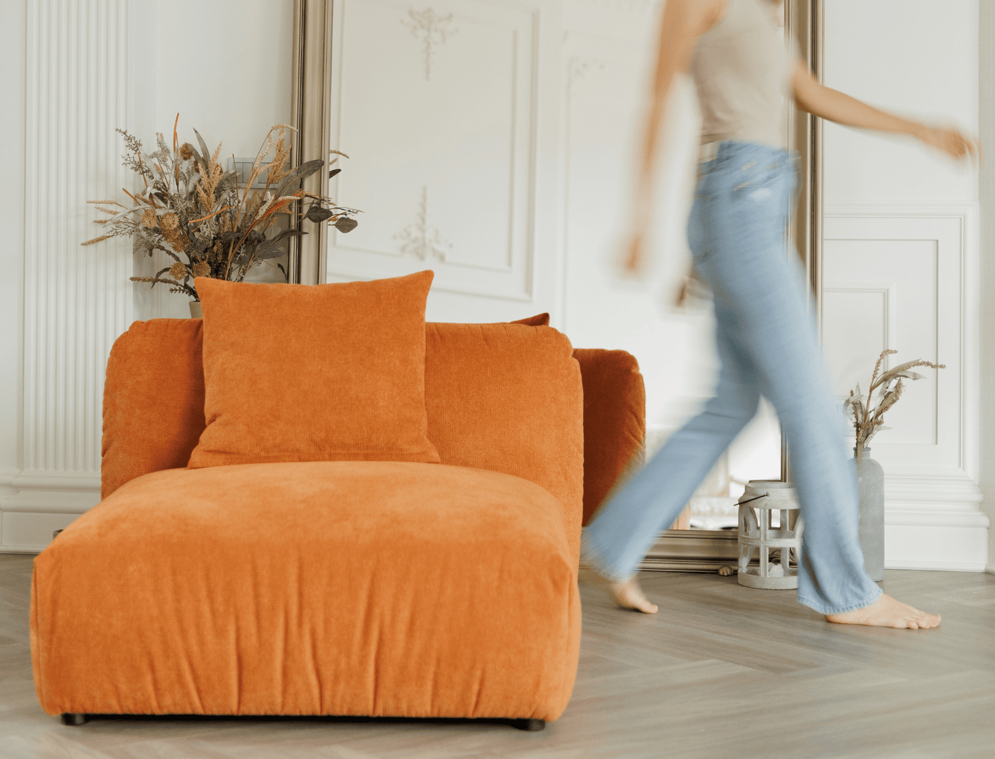 Contemporary armchair without armrests in textured orange fabric – a bold, modern touch.