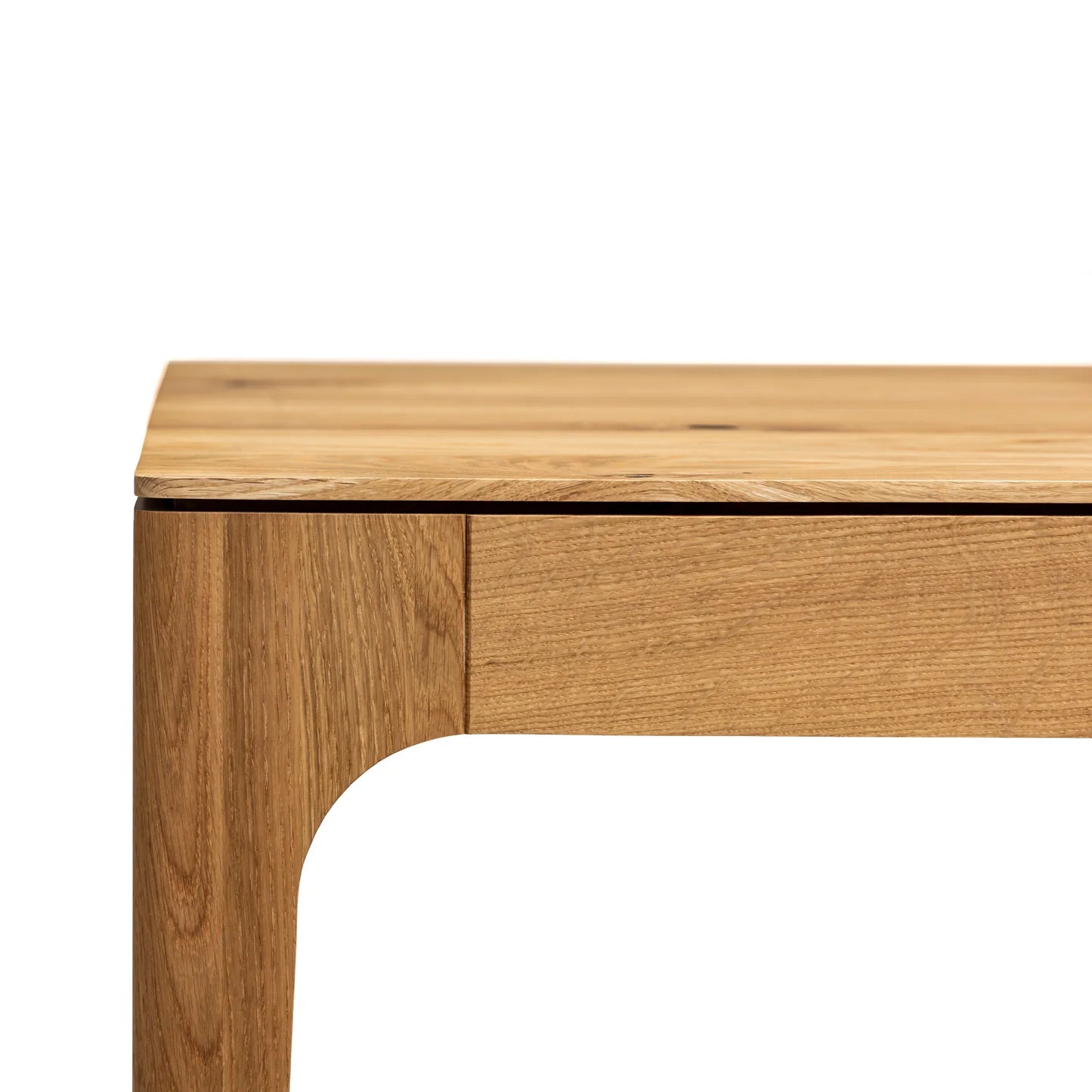 Rectangular solid wood dining table with hidden extension mechanism in natural oak.
