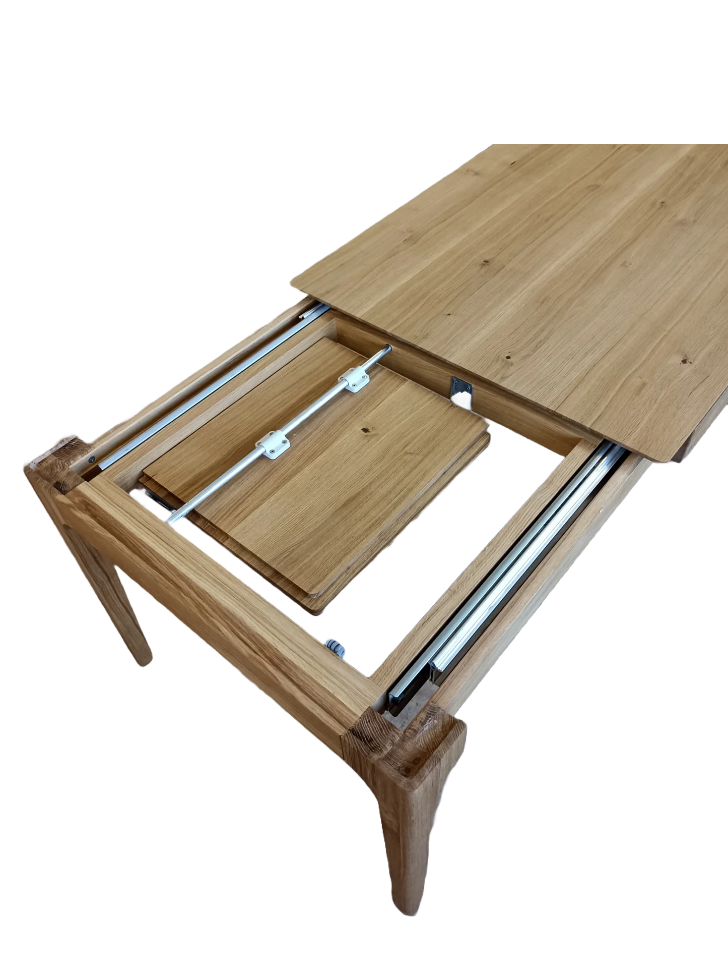 Rectangular solid wood dining table with hidden extension mechanism in natural oak.