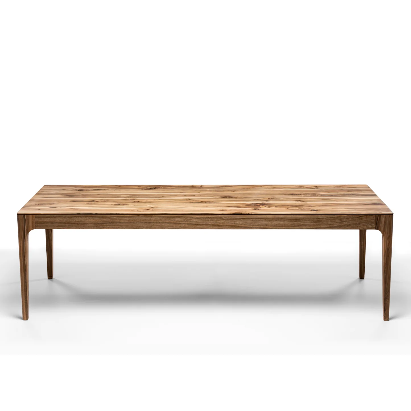 Rectangular solid wood dining table with hidden extension mechanism in natural walnut.