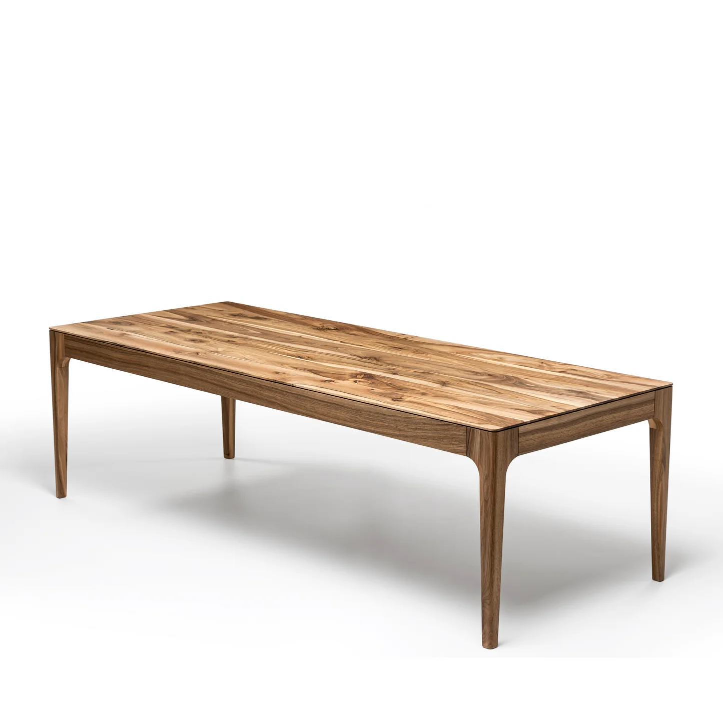 Rectangular solid wood dining table with hidden extension mechanism in natural walnut.
