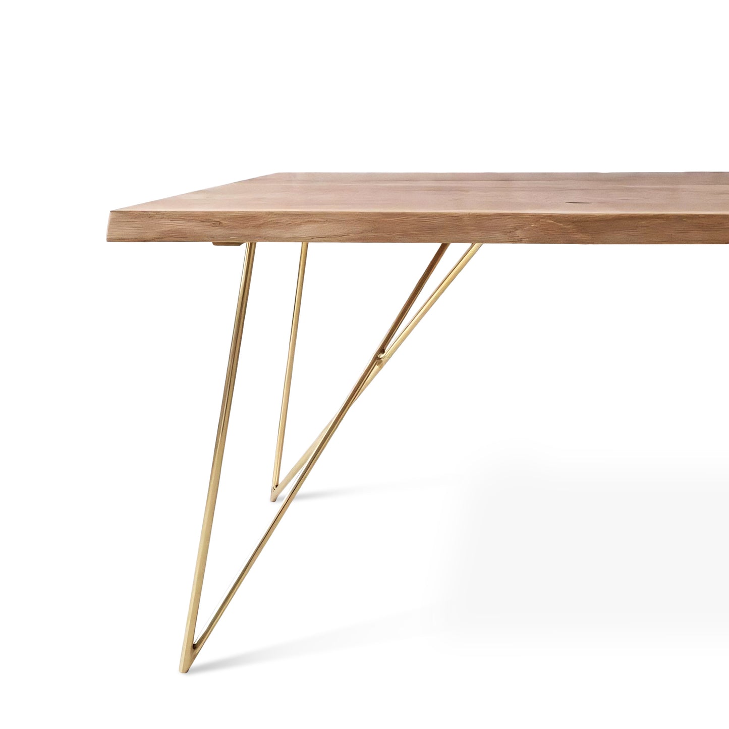 Close-up view of the Rhea solid wood dining table in oak or walnut with golden metal legs, featuring live or corner edge detailing.