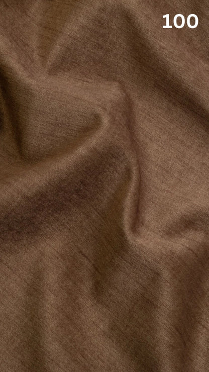 Close-up of brown velvet fabric texture with a slight pattern and number '100' in the corner. 