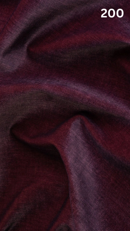 Close-up of wine colored velvet fabric for sofas with a slight pattern and number '200' in the corner. 