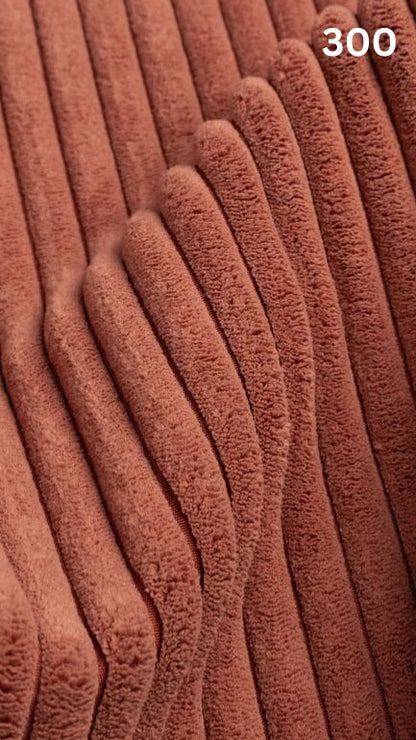 Close-up of orange textured premium corduroy fabric for sofas with a number '300' in the corner. 