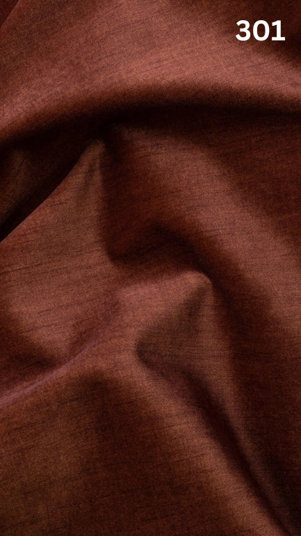 Close-up of orange colored velvet fabric for sofas with a slight pattern and number '301' in the corner. 