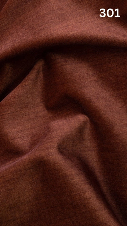 Close-up of orange colored velvet fabric for sofas with a slight pattern and number '301' in the corner. 