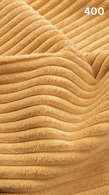 Close-up of yellow textured premium corduroy fabric for sofas with a number '400' in the corner. 