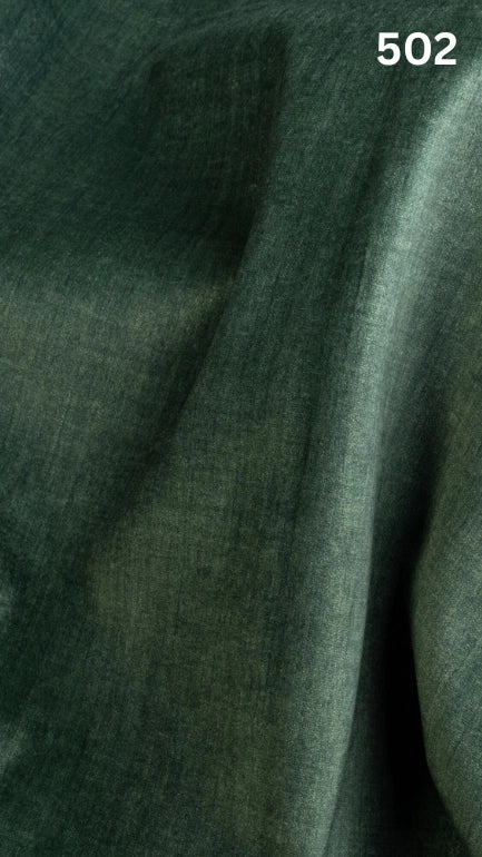 Close-up of green colored velvet fabric for sofas with a slight pattern and number '502' in the corner. 