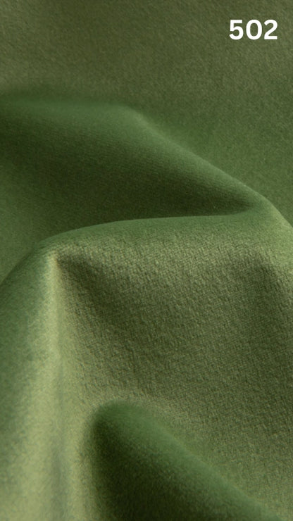 Premium velvet fabric for sofas in green with a number '502' in the corner. 