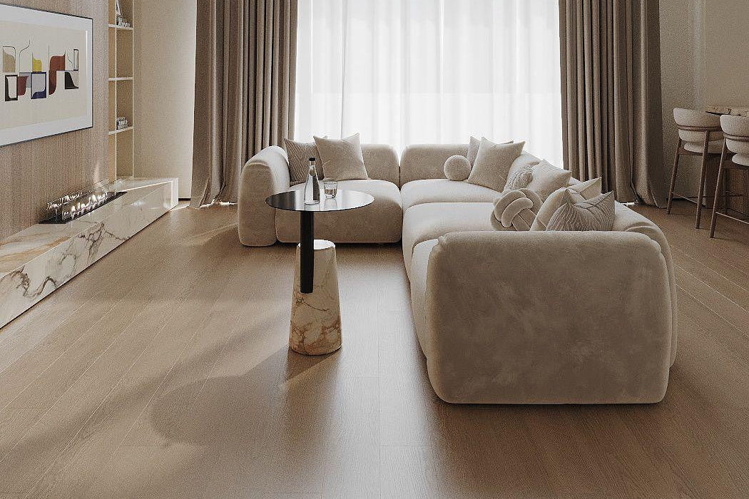 Modern living room with beige sofa, coffee table, and large windows with curtains.