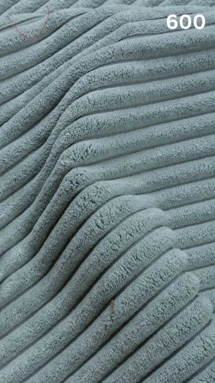 Close-up of blue textured premium corduroy fabric for sofas with a number '600' in the corner. 