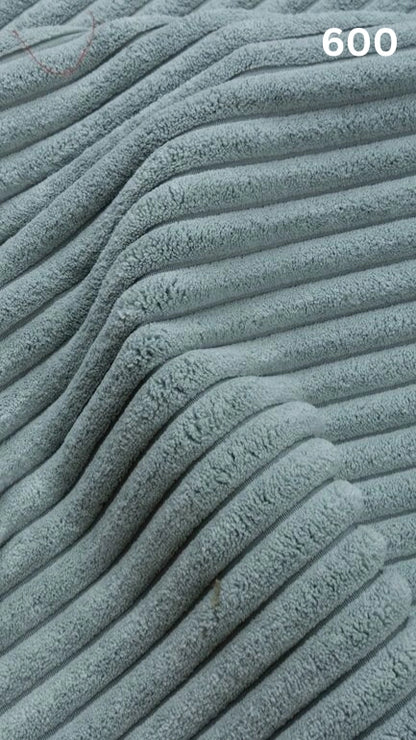Close-up of blue textured premium corduroy fabric for sofas with a number '600' in the corner. 