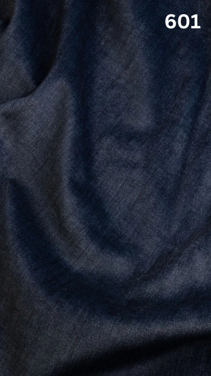 Close-up of blue colored velvet fabric for sofas with a slight pattern and number '601' in the corner. 