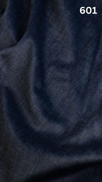 Close-up of blue colored velvet fabric for sofas with a slight pattern and number '601' in the corner. 