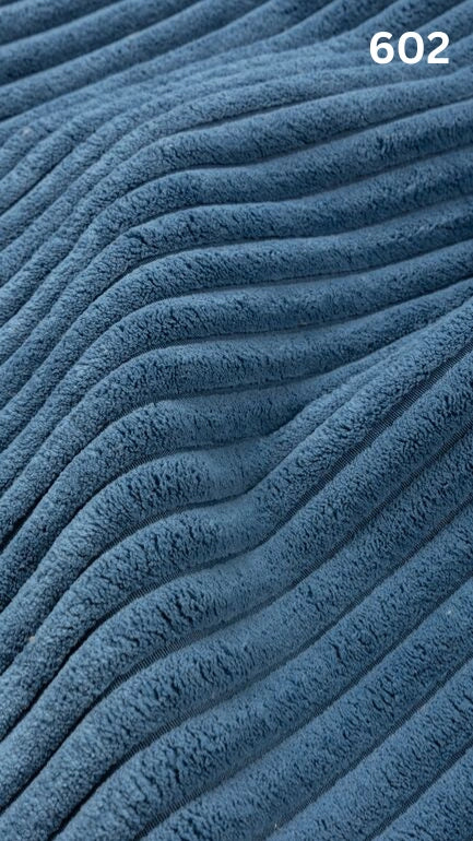 Close-up of blue textured premium corduroy fabric for sofas with a number '602' in the corner. 