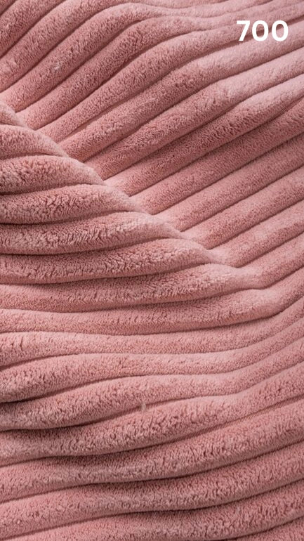 Close-up of pink textured premium corduroy fabric for sofas with a number '700' in the corner. 
