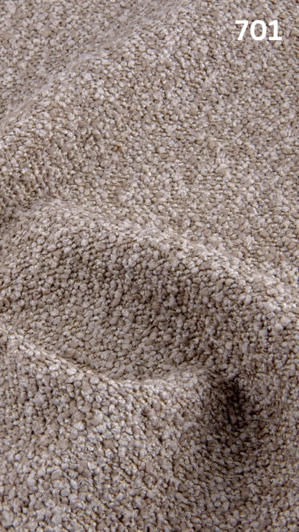 Close-up of textured beige bouclé fabric for sofas with a pattern and number '701' in the corner.