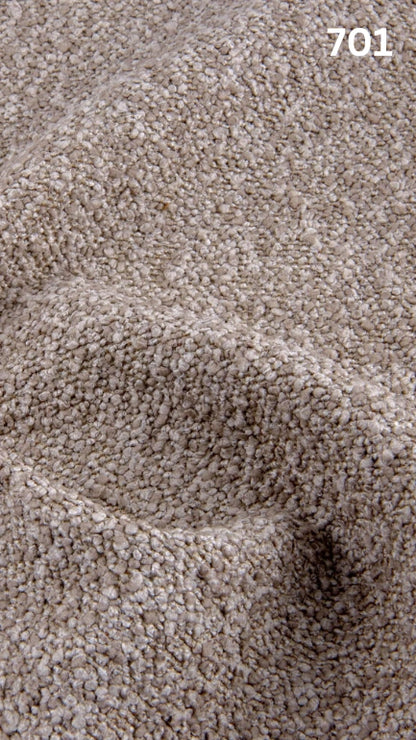 Close-up of textured beige bouclé fabric for sofas with a pattern and number '701' in the corner.