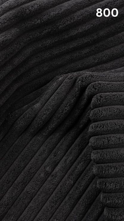 Close-up of black textured premium corduroy fabric for sofas with a number '800' in the corner. 