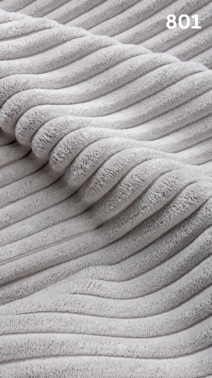 Close-up of white textured premium corduroy fabric for sofas with a number '801' in the corner. 