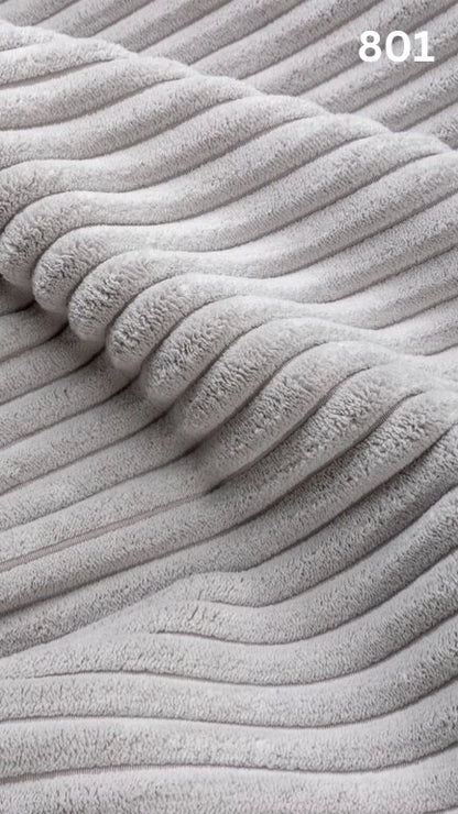 Close-up of white textured premium corduroy fabric for sofas with a number '801' in the corner. 