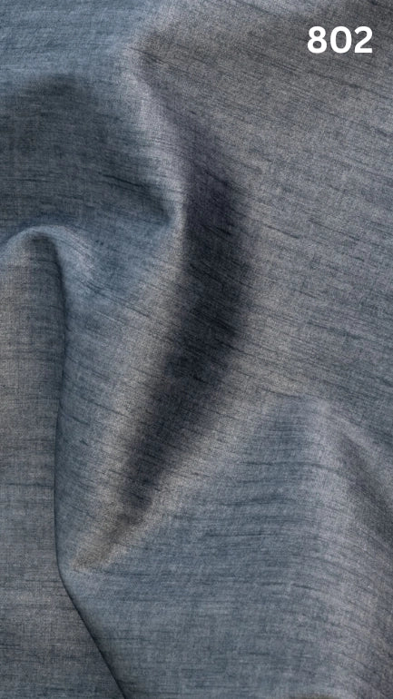 Close-up of light blue colored velvet fabric for sofas with a slight pattern and number '802' in the corner. 