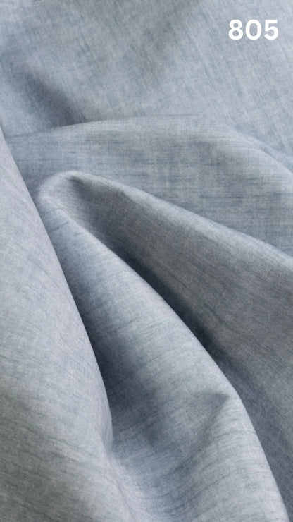 Close-up of light blue colored velvet fabric for sofas with a slight pattern and number '805' in the corner. 