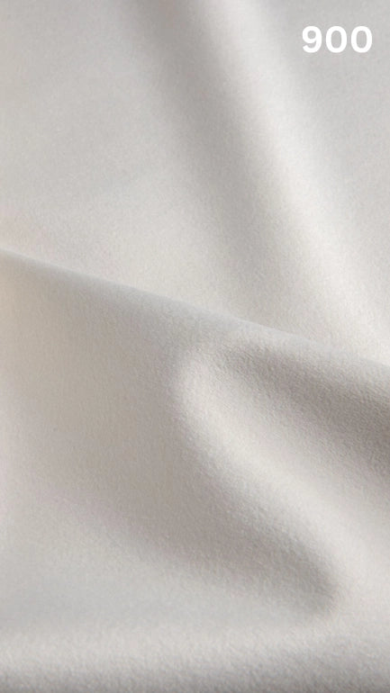 Premium velvet fabric for sofas in white with a number '900' in the corner. 