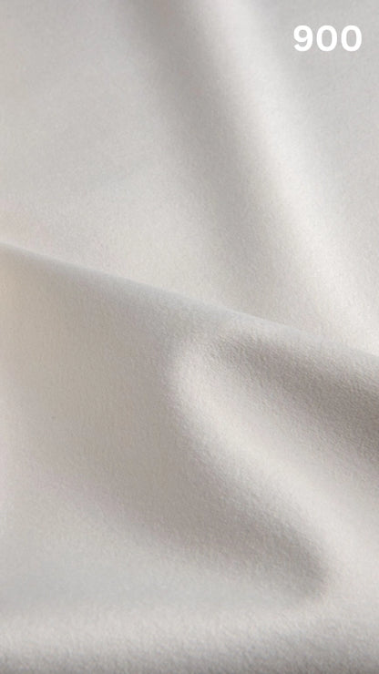 Premium velvet fabric for sofas in white with a number '900' in the corner. 