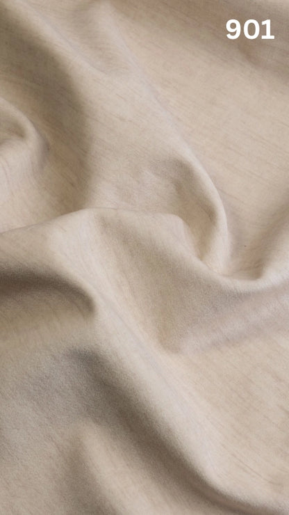 Close-up of cream colored velvet fabric for sofas with a slight pattern and number '901' in the corner. 