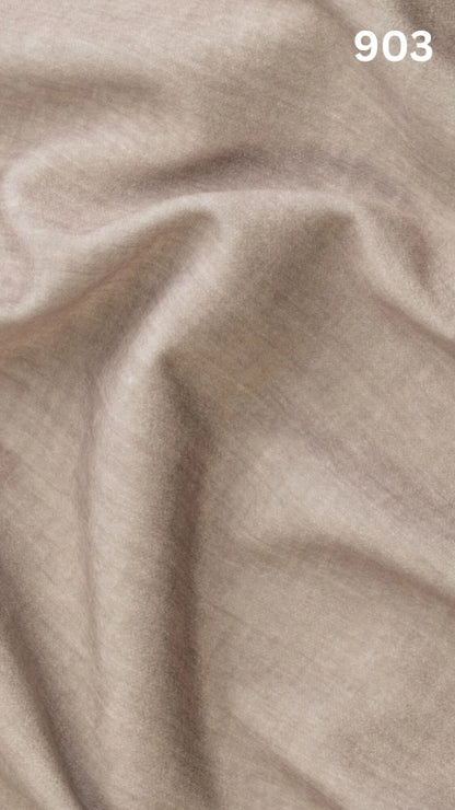 Close-up of beige colored velvet fabric for sofas with a slight pattern and number '903' in the corner. 