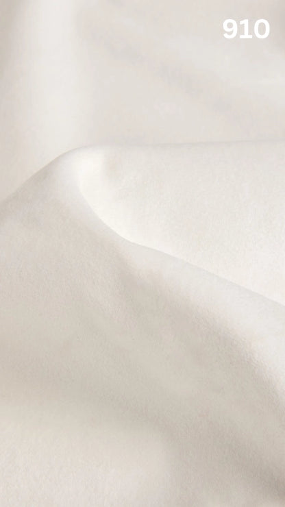 Premium velvet fabric for sofas in white with a number '910' in the corner. 