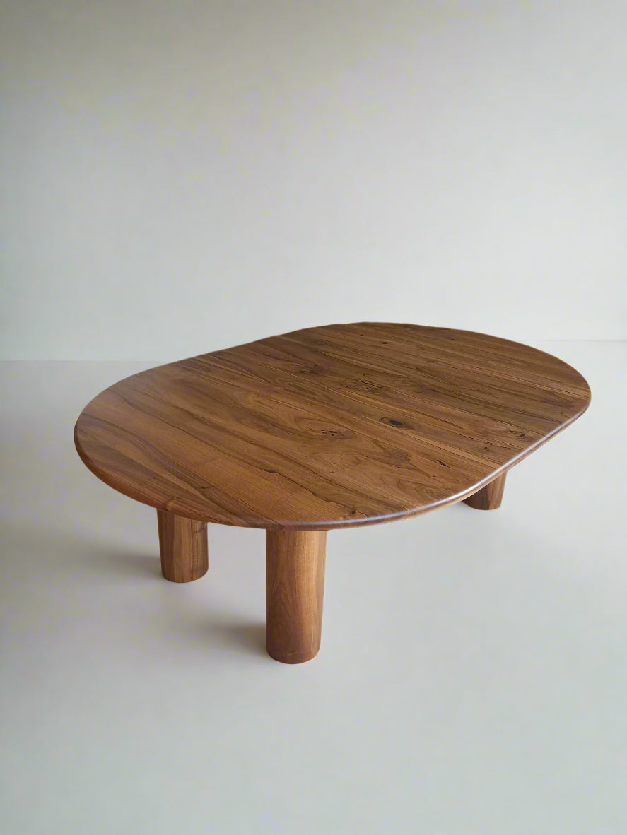 Ameline bespoke round dining table crafted from FSC certified solid walnut wood planks, featuring a minimalist designer style. This premium, sustainable piece by Talia Haus blends custom craftsmanship with luxury design, available in oak or walnut and extendable options for versatile dining spaces.