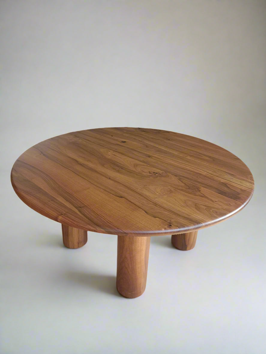 Ameline bespoke round dining table crafted from FSC certified solid walnut wood planks, featuring a minimalist designer style. This premium, sustainable piece by Talia Haus blends custom craftsmanship with luxury design, available in oak or walnut and extendable options for versatile dining spaces.