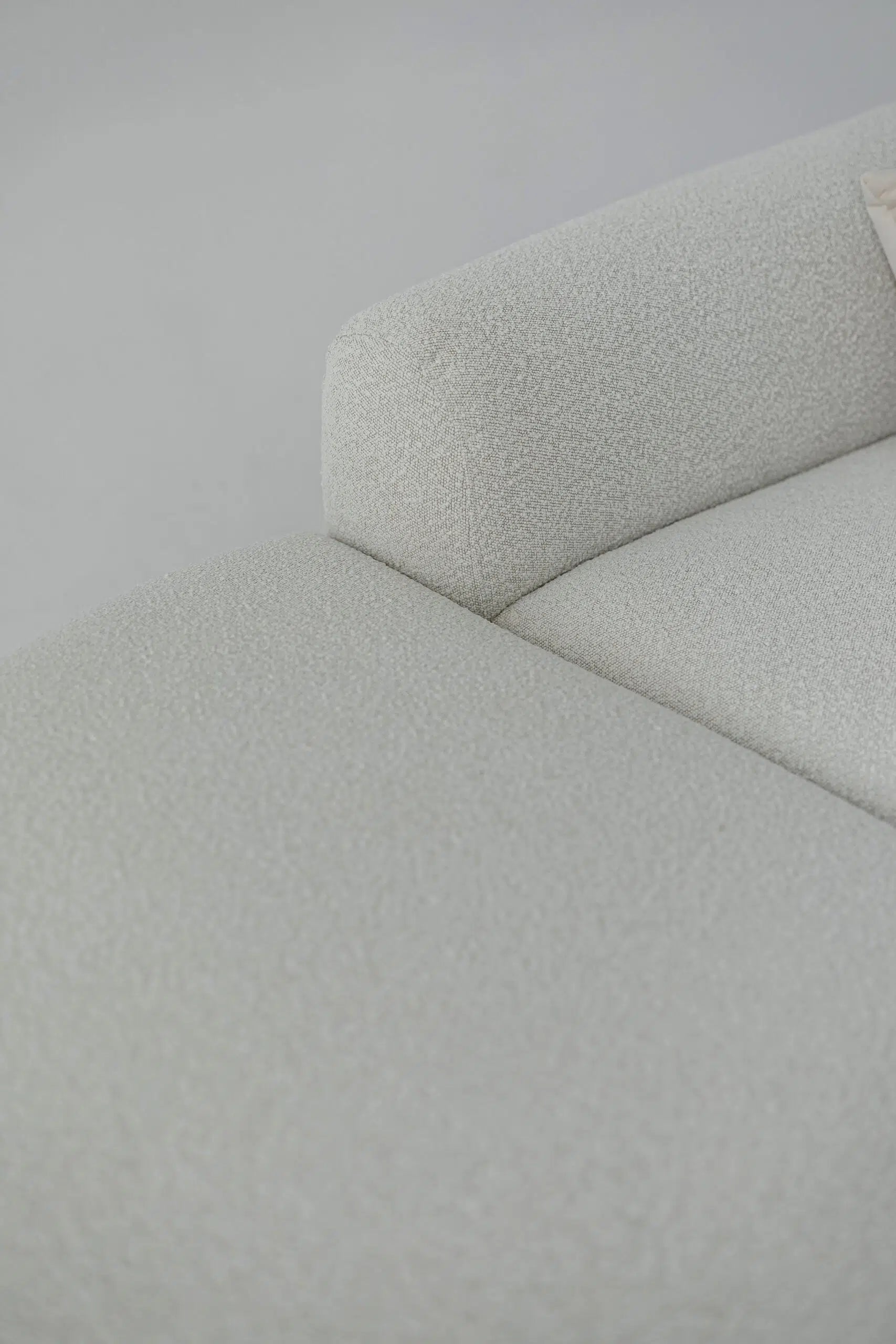 Close-up of a white boucle sofa corner