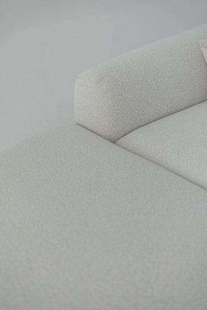 Close-up of a white boucle sofa corner